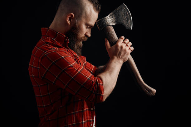 istock lumberjack. Confident bearded man attached to forehead axe 2161414166