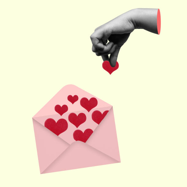 istock The human hand put a red heart into a letter 2161414770