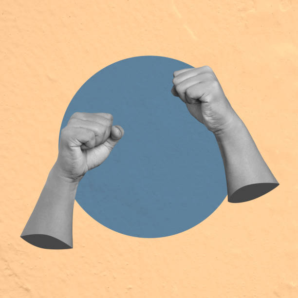 istock Two hands forming fists showing strength and power on blue circle 2161414797