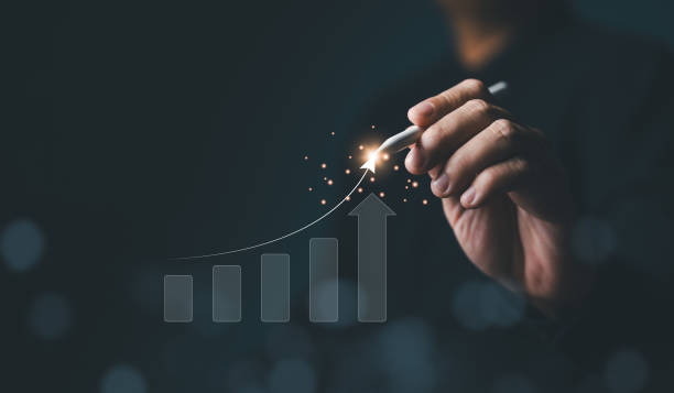 istock Strategic planner, Analyst, Investor, or Trader analyzing data to increase profits and company growth. Hand with many increasing bar graph charts for stock investments. Business strategy concept. 2161414823