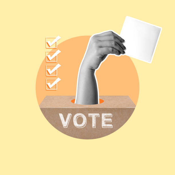 Human hand from ballot box holding ballot