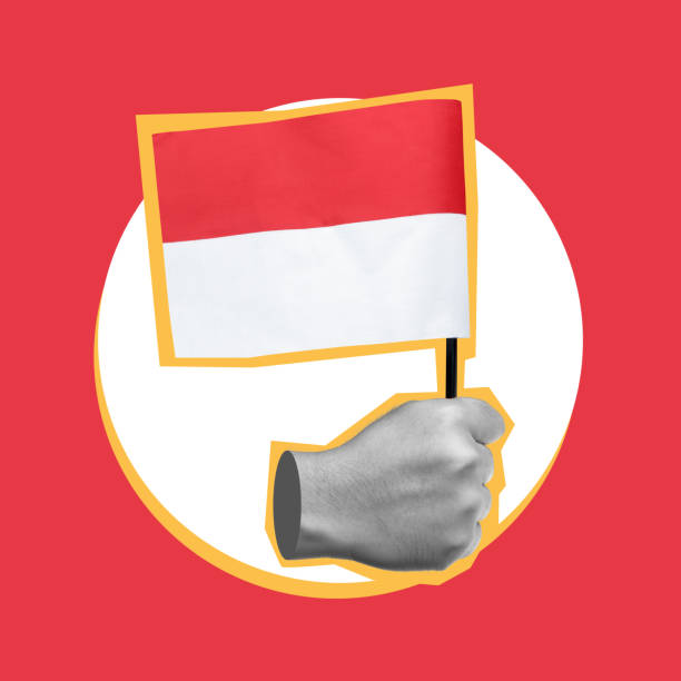 Human hand holding the Indonesia flag to celebrate Indonesian Independence Day