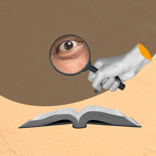 istock Human eyes look at a book through a magnifying glass 2161416476