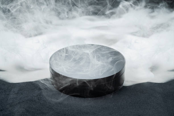 istock Round black podium surrounded by smoke on black sand 2161416570