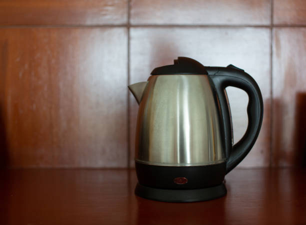 istock Stainless steel electric kettle placed on a wooden table top. 2161417206