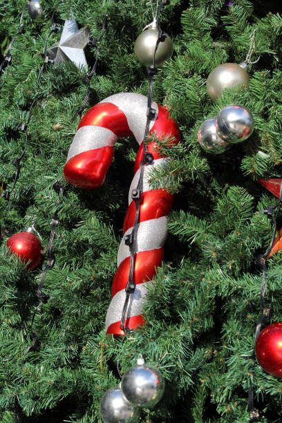 istock Christmas tree decorated with a candy cane and silver and red bauble ornaments 2161417493