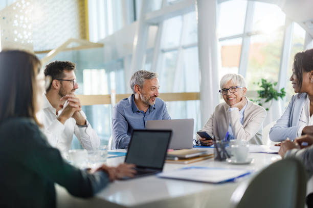 istock Happy entrepreneurs talking during a constructive meeting in the office. 2161419962