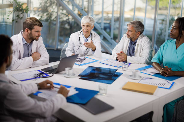 istock Team of general practitioners talking on a meeting at doctor's office. 2161420058