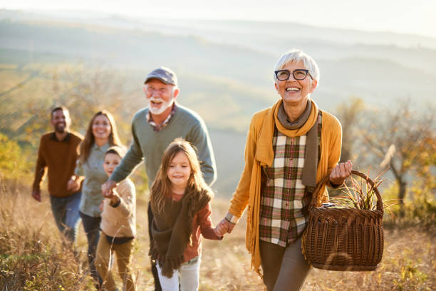 istock Happy multi-generation family going on a picnic in autumn day. 2161421864