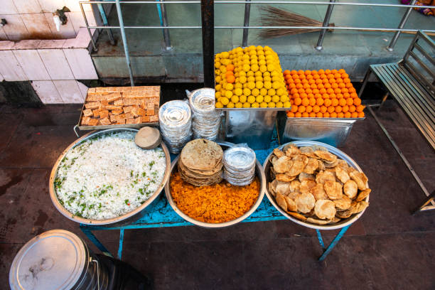 A food shop showcasing a variety of sweets including rice, puri, barfi, and halwa.