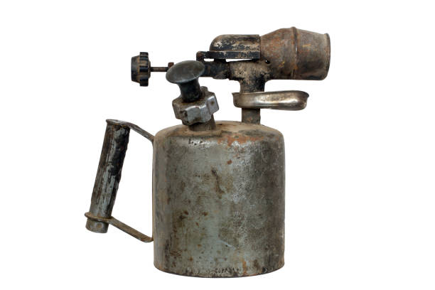 An old blowtorch isolated on a white background. An old blowtorch isolated on a white background. Close-up of a gasoline blowtorch. vintage blow torch stock pictures, royalty-free photos & images