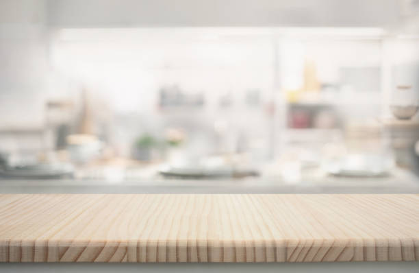 istock Wood table top counter  island  on blur minimal  contemporary kitchen 2161425740