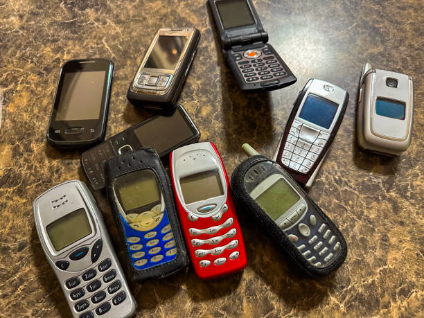 Close-up of an old and obsolete cell phone on a white background. Vertical.7