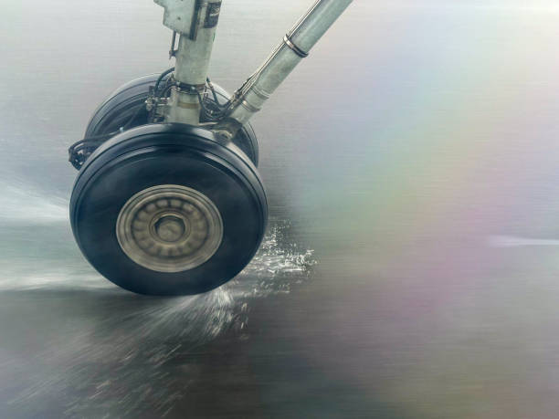 Aeroplane wheel landing on a wet tarmac