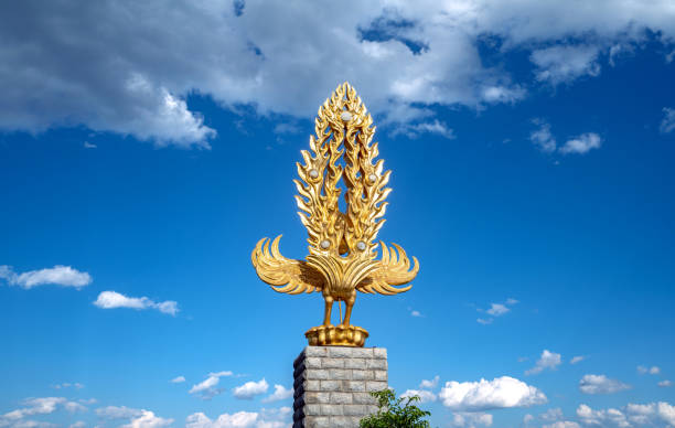 New Orleans, Louisiana in Mardi Gras Carnival Celebrations. Golden statue of Joan of Arc riding a horse and holding a gold flag waving in the wind in front of a clear blue sky in New Orleans, Louisiana, USA