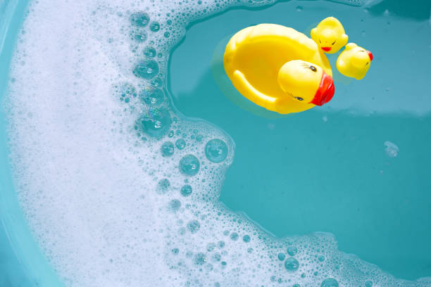 istock Yellow rubber ducks in water with soap foam 2161430460
