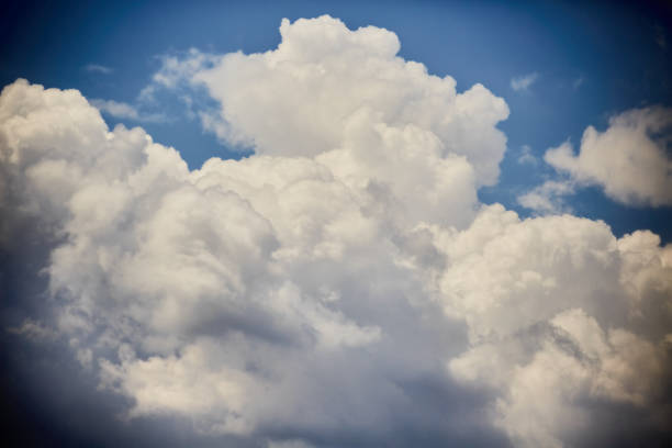 A tall white cloud in a blue sky, a fabulous white cloud as a tower, close up