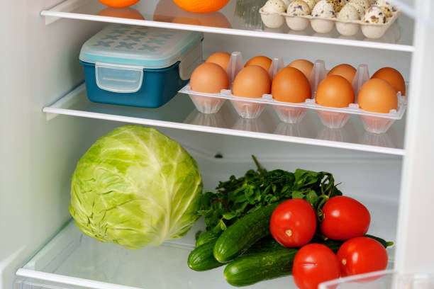 istock Well-Stocked Refrigerator With Fresh Produce, Eggs, and Other Groceries 2161432513