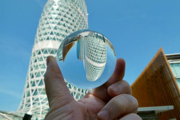 istock Hand holding crystal ball with skyscraper background 2161434731