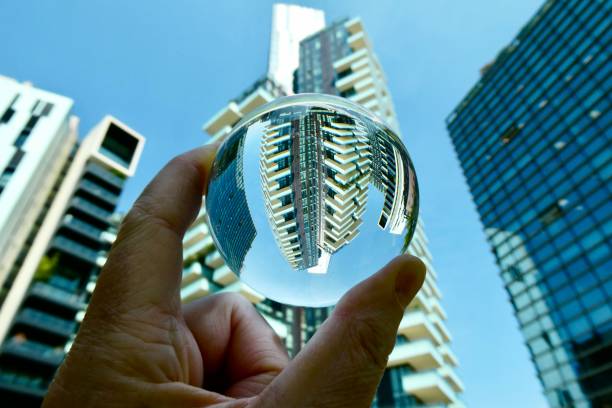 istock Hand holding crystal ball with skyscraper background 2161434736
