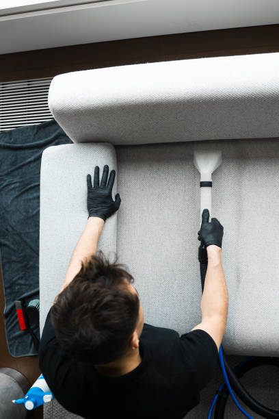 istock Using extractor to refresh and clean from dust and stains upholstered furniture. Cleaner is dry-cleaning sofa using extractor machine with detergent. 2161439399