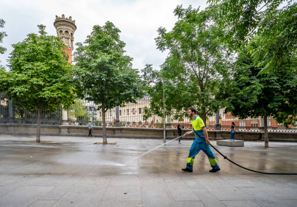 Madrid, Spain. 29 June 2024. Street cleaner in Madrid uses a high pressure hose.