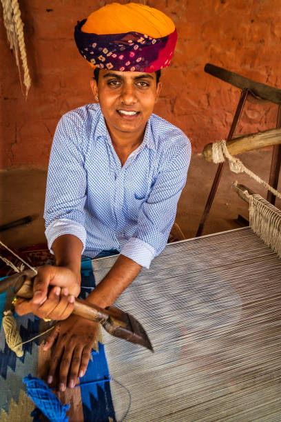 istock Indian man weaving textiles (durry) in Rajasthan 2161442387