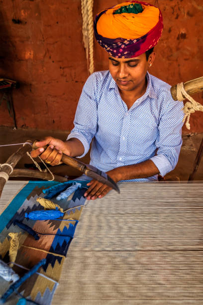 istock Indian man weaving textiles (durry) in Rajasthan 2161442408