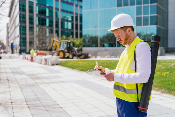 istock Quality Inspector Writing on Clipboard at Construction Site 2161442494