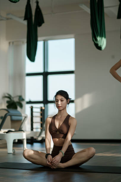 istock A beautiful female yoga instructor sits on a mat meditating 2161447420
