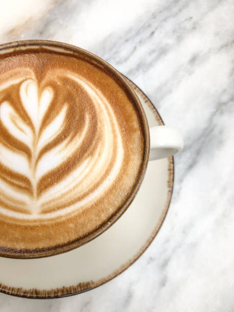 istock cappuccino coffee with latte art on marble table 2161447426