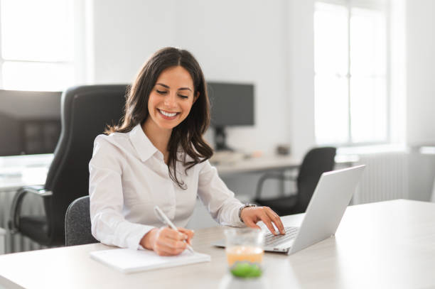 istock Young female entrepreneur working at her desk in bright modern office 2161449375