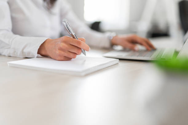 istock Close shot of persong writing down notes with pencil 2161449513
