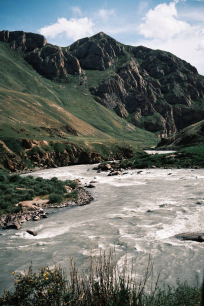 istock Winding mountain stream in lush summer valley 2161453157