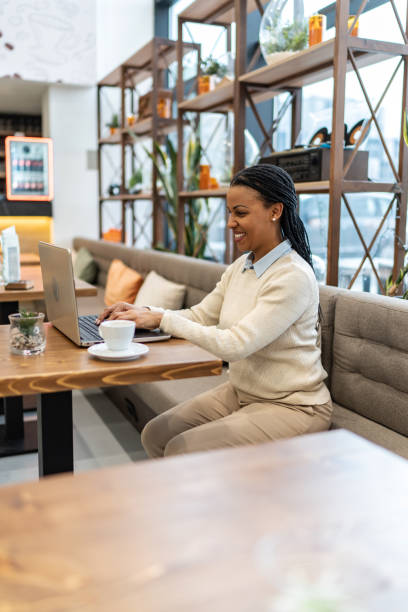 istock Focused African woman working online in a cafe 2161453612