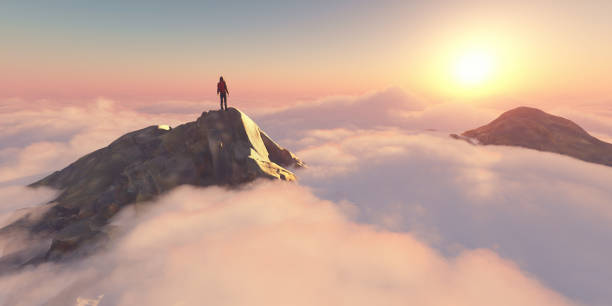 istock A man standing on a stone cliff over the clouds .Success concept. 2161455833