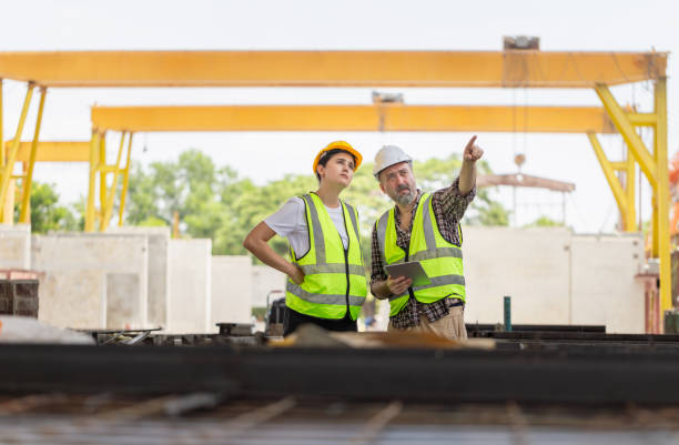 istock Engineer and foreman in hardhats discussing on construction site, Engineer and worker team with tablet checking project at the precast concrete factory site 2161458440