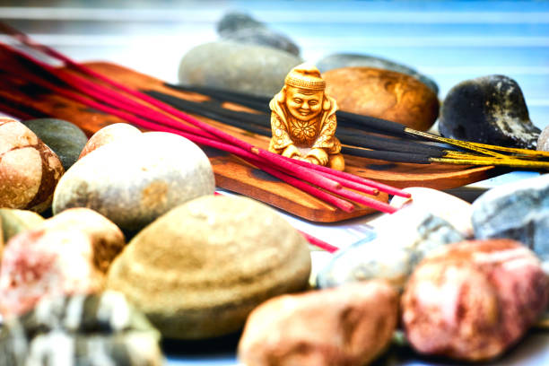 istock Statuette of a Buddhist monk among incense and various stones 2161458900