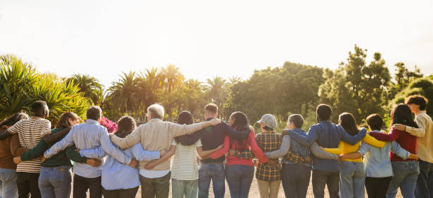 istock Group of multigenerational people hugging each others - Support, multiracial and diversity concept - Main focus on senior man with white hairs 2161459590