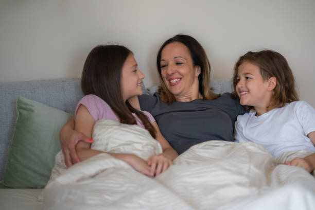 istock Mother lying i bed whit her children 2161460422