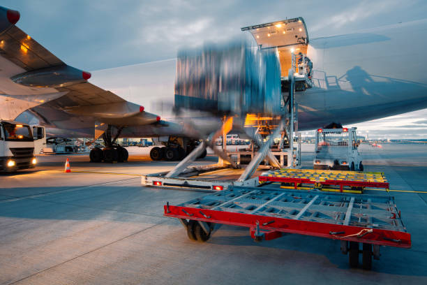 Preparation large cargo airplane before flight. Unloading and loading of freight container at airport.