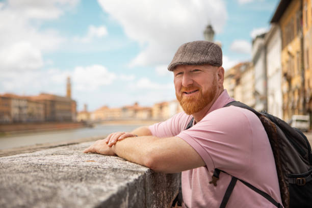 Handsome mature male tourist enjoying a sightseeing day in Pisa, Italy