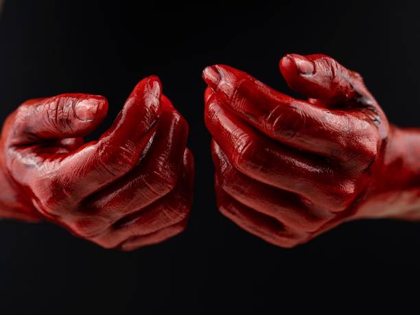 istock Women's hands in blood on a black background. 2161463021