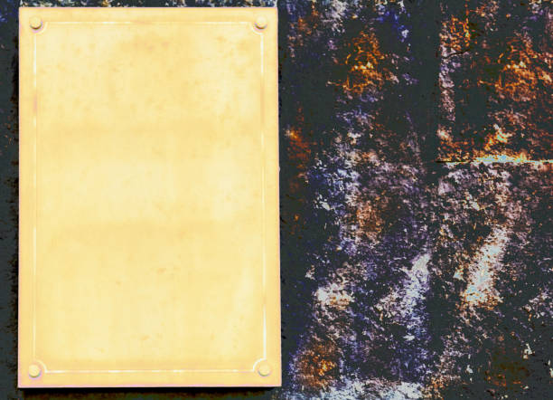 istock Yellow plaque with place for text on brown granite wall 2161464726