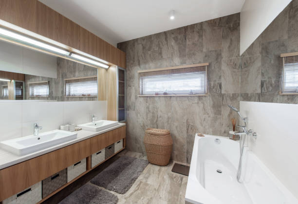 istock Bright Elegant Modern Bathroom Interior Design of White Bath, Sink, Mirror. Bathroom Accessories, Gray Tile Walls, LED Light. 2161465185