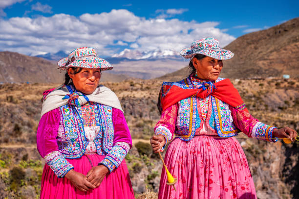 istock Peruvian women spinning wool by hand near Colca Canyon, Peru 2161465197