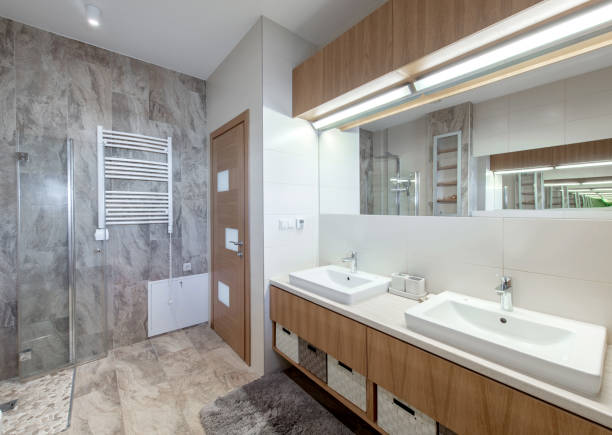 istock Bright Elegant Modern Bathroom Interior Design of White Sink, Mirror, Heater. Bathroom Accessories, Gray Tile Walls, LED Light. 2161465205