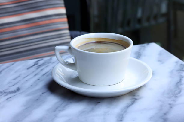 istock Cup of coffee on marble table 2161466295