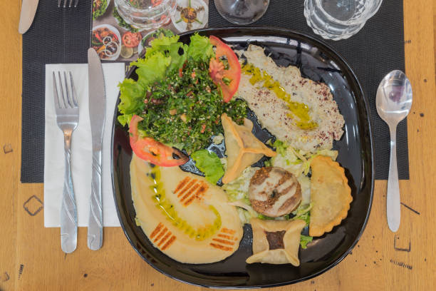 istock Dumplings with mint salad and hummus on a plate 2161467115