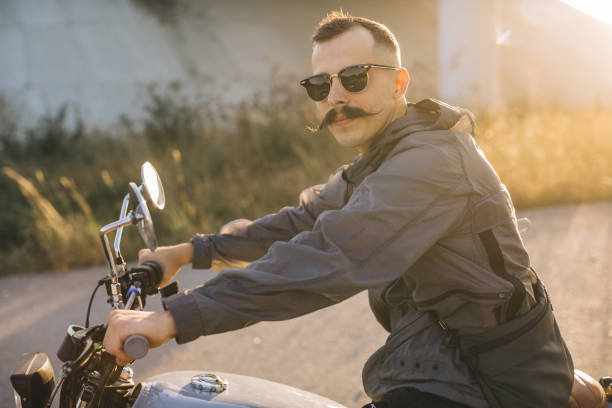 istock A young male biker rides a motorcycle on a sunny summer day. 2161467510